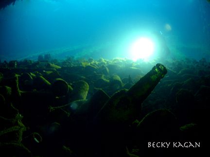 Wine and Sake bottles scattered across the cargo hold of ... by Becky Kagan 