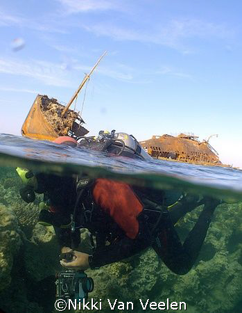 Over / under shot of my buddy taken at the end of a dive.... by Nikki Van Veelen 