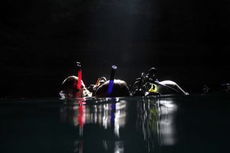 Cave divers ready to descend in Devil's Den, FL. Light co... by Ting Tsui 
