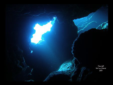 Natural light entering the famous Snapper Hole on the Eas... by Neil Van Niekerk 