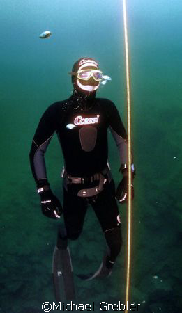 A smiling free diver on his way back to the surface durin... by Michael Grebler 