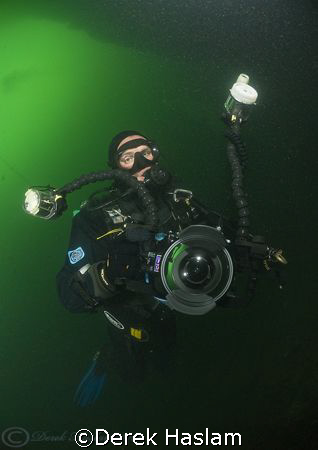 Mark in the green water's of Vivian quarry. D200, 10.5mm. by Derek Haslam 