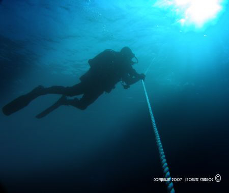 Diver decompressing on an ascent line, on one of the many... by Steve Jarocki, Jr. 