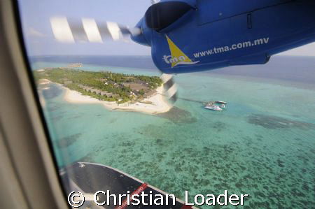 Seaplane coming in to land at the resort i work at. Landa... by Christian Loader 