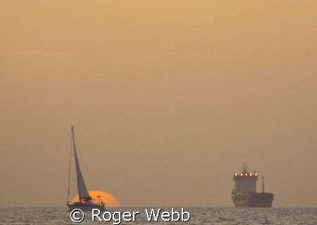 Bequia at sundown... by Roger Webb 
