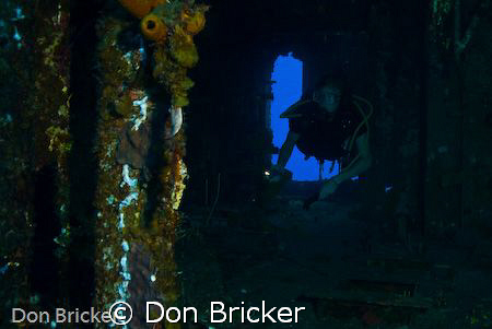 My son exploring the inside of the HMS Tibbet off the coa... by Don Bricker 