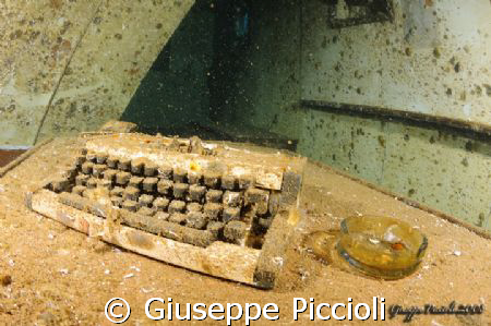 This typewriter and ash cup is placed onto the table of t... by Giuseppe Piccioli 