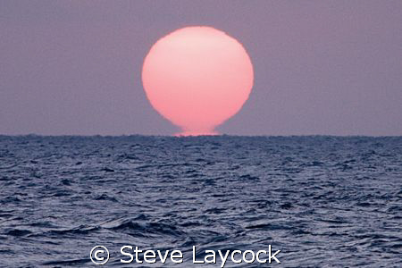 Sunrise - proof that the sun is melting and heating up th... by Steve Laycock 