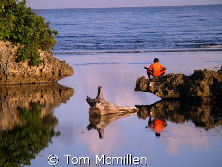 A young boy reflects. Roatan Honduras. by Tom Mcmillen 