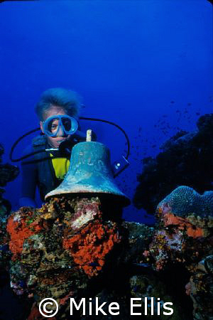 Capt. Kevin Davidson with the ships bell. Truk lagoon, Un... by Mike Ellis 