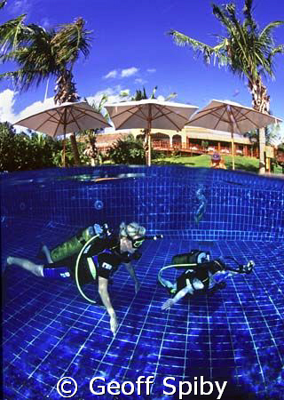 a young new diver receiving lessons in the hotel pool, In... by Geoff Spiby 