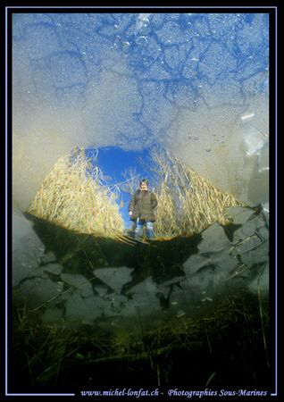 Sophie waiting for us.... Diving under the ice... close t... by Michel Lonfat 