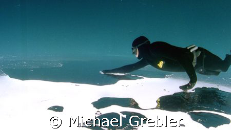 Apnea Diver under ice, Morrisons Quarry, Quebec, Canada. ... by Michael Grebler 