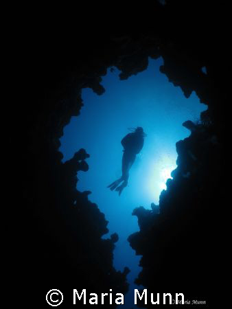 The Canyon in Dahab with the Dive Guide finning backwards... by Maria Munn 