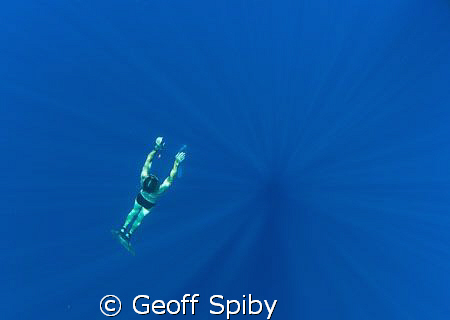 a freediver returning from the depths by Geoff Spiby 