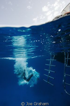 Diver taking the plunge from a liveaboard vessel. Red Sea... by Joe Graham 