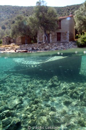 A sunken fishing boat in shallow waters in Pelion. by Vasilis Lekkas 