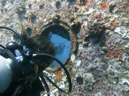 Menna looking through a portside porthole on the AnnAnn W... by Mish Bayoumi 