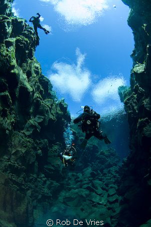 Divers in Silfra, Iceland. Melted glacierwater, many year... by Rob De Vries 