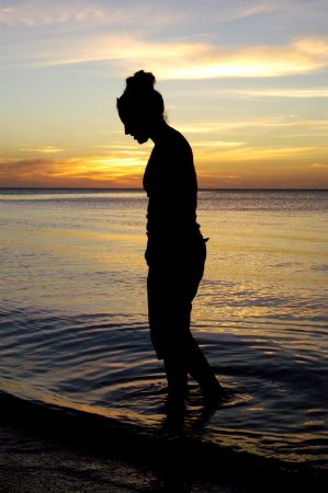 Wet feet abd beautiful sunset on the island of Roatan. by Shawn Jackson 