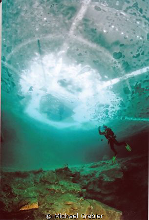 Dive tenders cut a pattern of safety lines in the snow ab... by Michael Grebler 