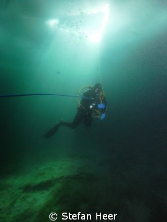 Ice Diving in the mountains of Switzerland. Diver with su... by Stefan Heer 