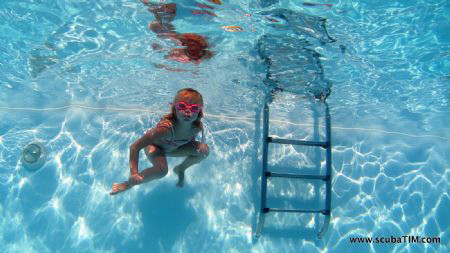 Little girl in pool... by Tim Ho 