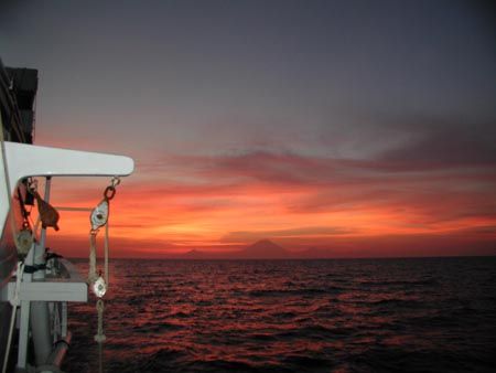 Komodo Sunset over Volcano with smoooth Sailing. by Dale Treadway 