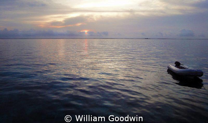 Sunrise from the Sun Dancer off Terneffe Atoll. by William Goodwin 