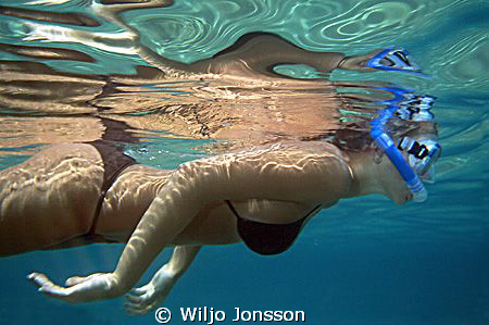 Young woman skindiving in the Sea of Crete. by Wiljo Jonsson 