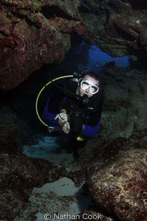 A diver in a swim through off the coast of Grand Cayman. by Nathan Cook 