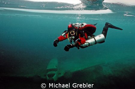 Tech diver under the ice in Morrison's Quarry, Quebec. Ni... by Michael Grebler 