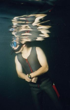 A dive instructor keeps an eye on his novice Open Water s... by Michael Grebler 