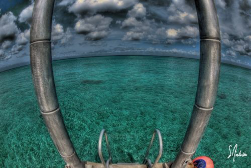 Waiting for the the boat to make our morning dives during... by Steven Anderson 