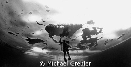 Tech diver under ice, Morrison's Quarry. Ice curvature ef... by Michael Grebler 