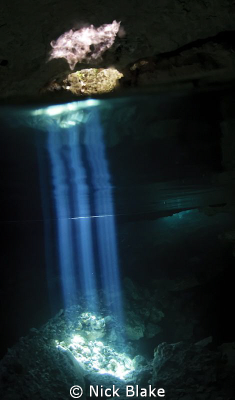 Light beams in Taj Maha Cenote, Riviera maya, Mexico. by Nick Blake 