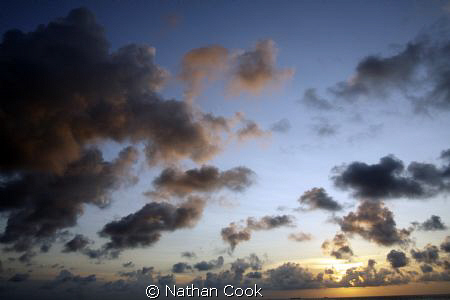 Sunset clouds over the water in Cozumel Mexico. by Nathan Cook 