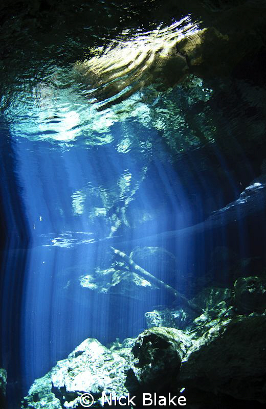 Light beams in Taj Maha Cenote, Mexico. by Nick Blake 