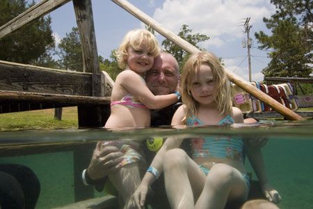 My Dive Buddy Dave is greeted by his daughters after a di... by Michael Shope 