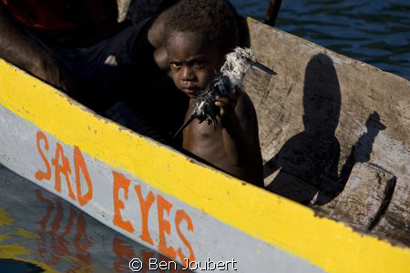 This boy was showing us his dead bird, and that combined ... by Ben Joubert 