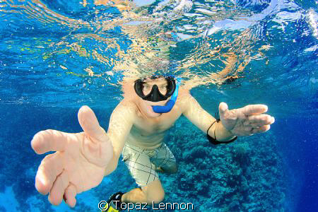 A close up with fish eye lense of friend snorelling in th... by Topaz Lennon 
