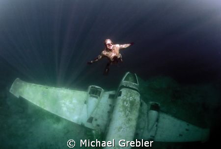 Apnea diver returning to the ice entry hole in Morrison's... by Michael Grebler 