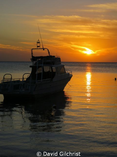 Sunset,West End, Roatan Honduras with  Native Sons Dive b... by David Gilchrist 