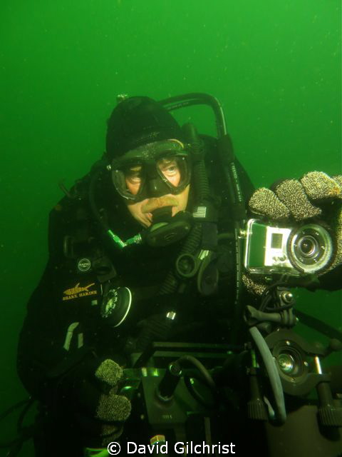 Diver adjusts Go Pro camera mounted on top of the Shark M... by David Gilchrist 
