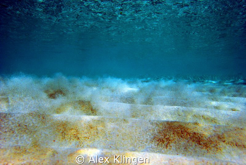 Sand breaking loose from the bottom due to wave action. M... by Alex Klingen 