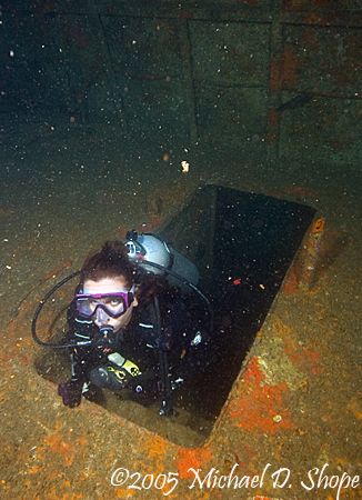 A diver works her way up through the an opening on the Bl... by Michael Shope 