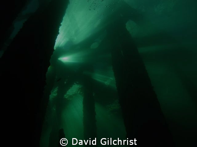 Silhouette, beneath the Piers at the Swing Bridge site, W... by David Gilchrist 