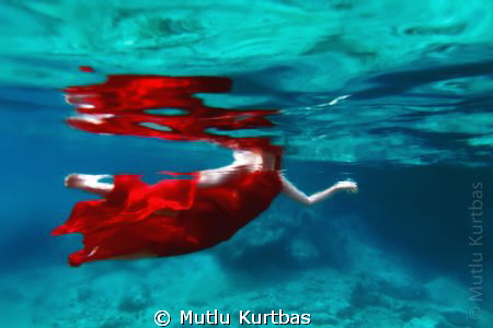 She is swimming in the sea with red dress and fresh water... by Mutlu Kurtbas 