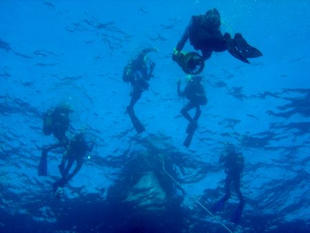 Divers starting a dive on south coast of Menorca. by Steven Withofs 