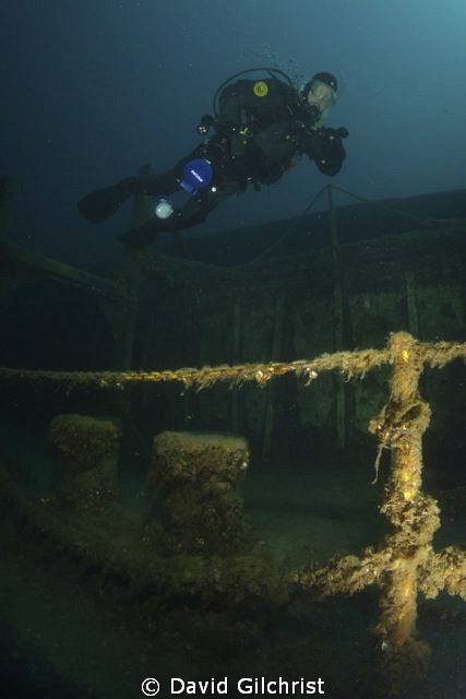 Diver swimming along Port side of the Niagara II, Tobermo... by David Gilchrist 